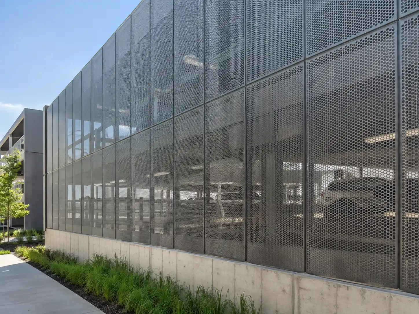 Modular perforated metal screen wall panels installed on a commercial building exterior