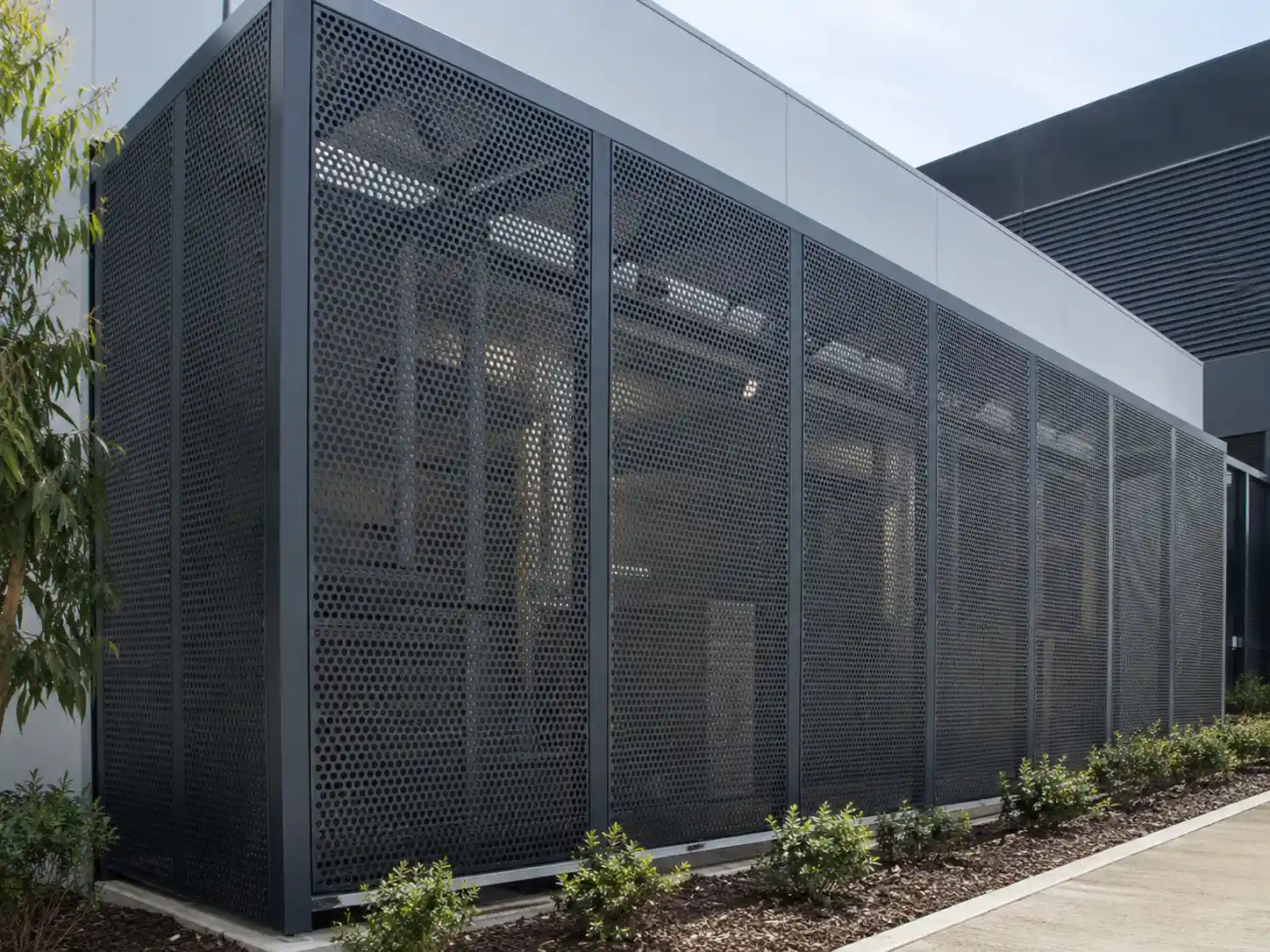 Perforated metal screening system used to provide airflow, visibility control and exterior protection