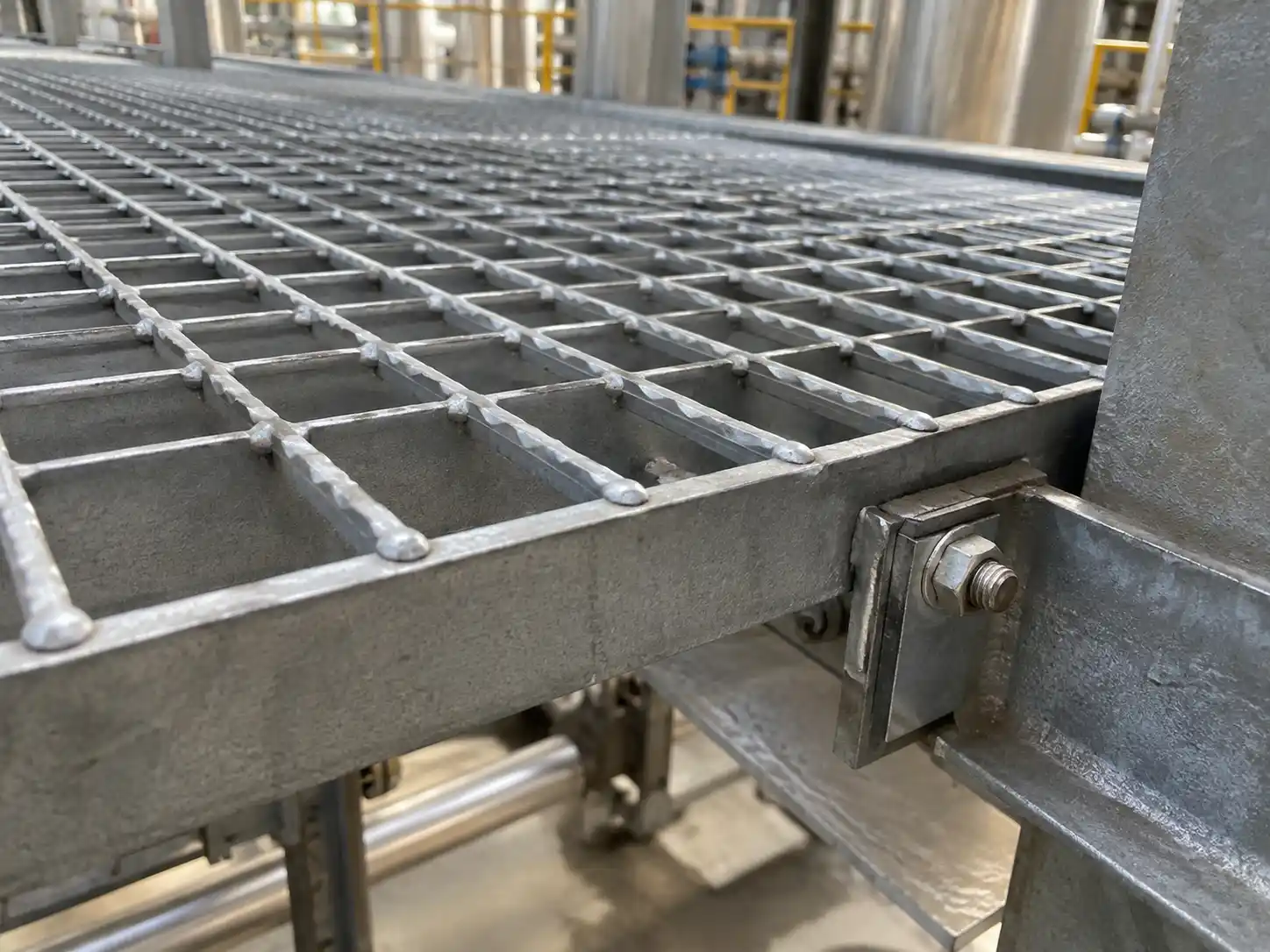 Riveted Bar Grating Fasteners Hold-down fastening system securing riveted bar grating to a steel support structure