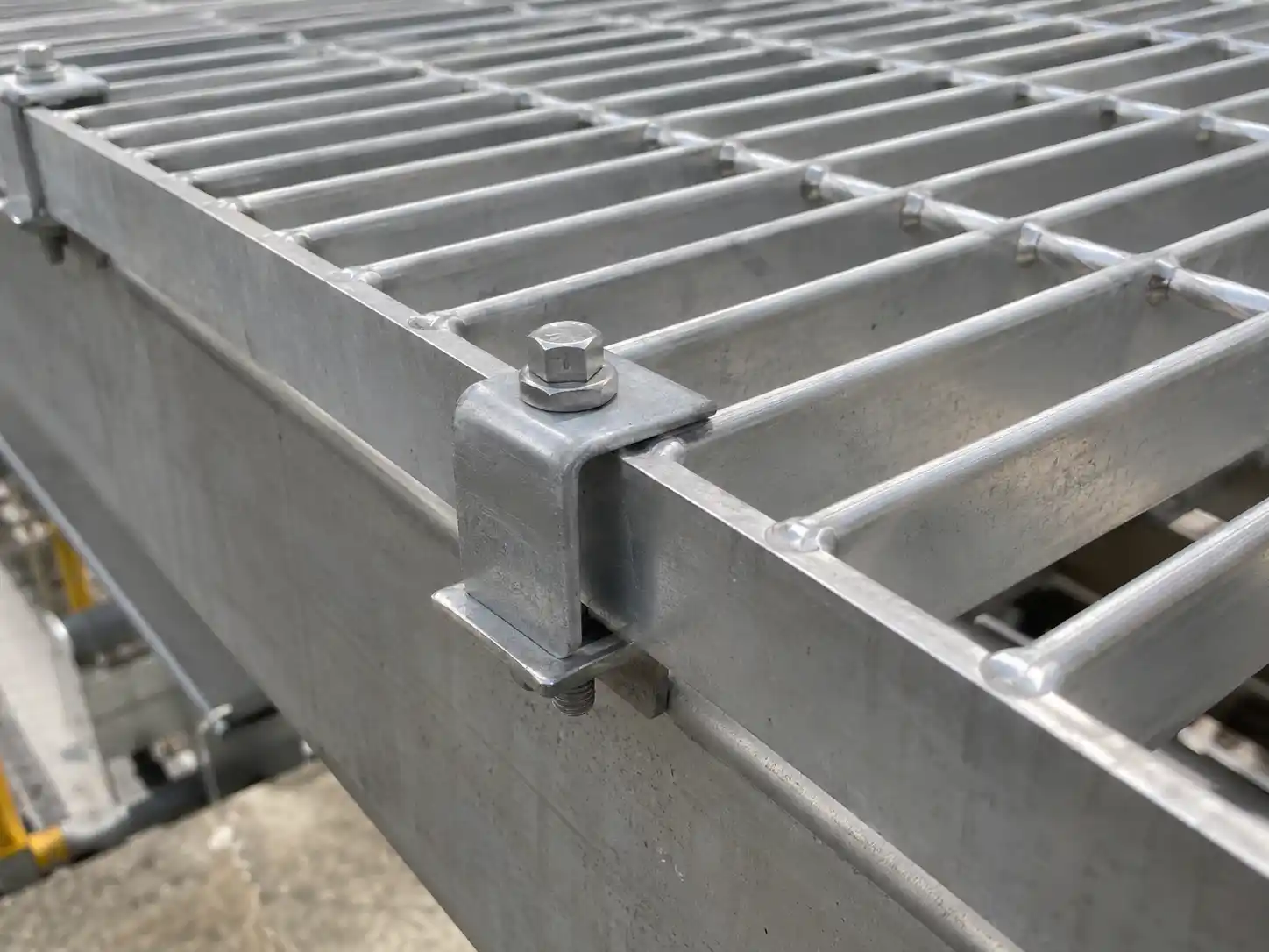 Swage-Locked Bar Grating Fasteners Mechanical fastener securing swage-locked bar grating to a structural support for removable access applications
