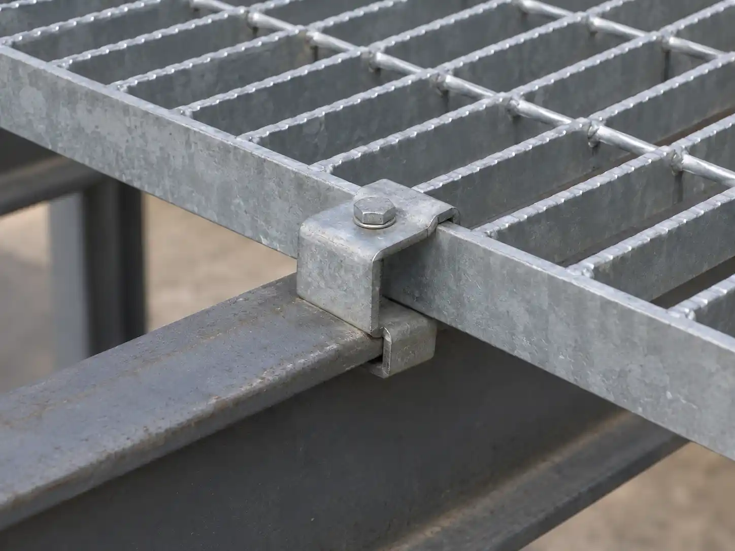 Welded Bar Grating Fasteners Mechanical clip securing welded bar grating to a structural steel support for removable industrial installation